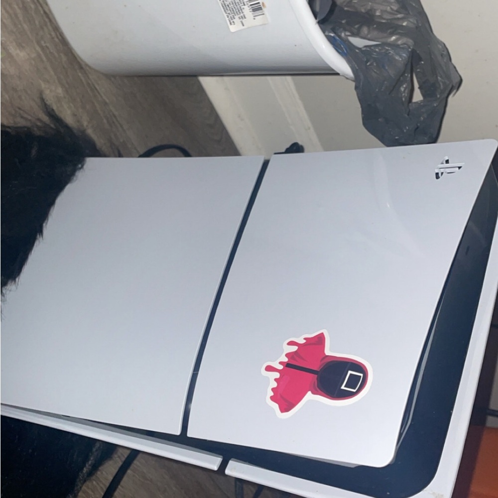 White Gaming Console with Red Sticker